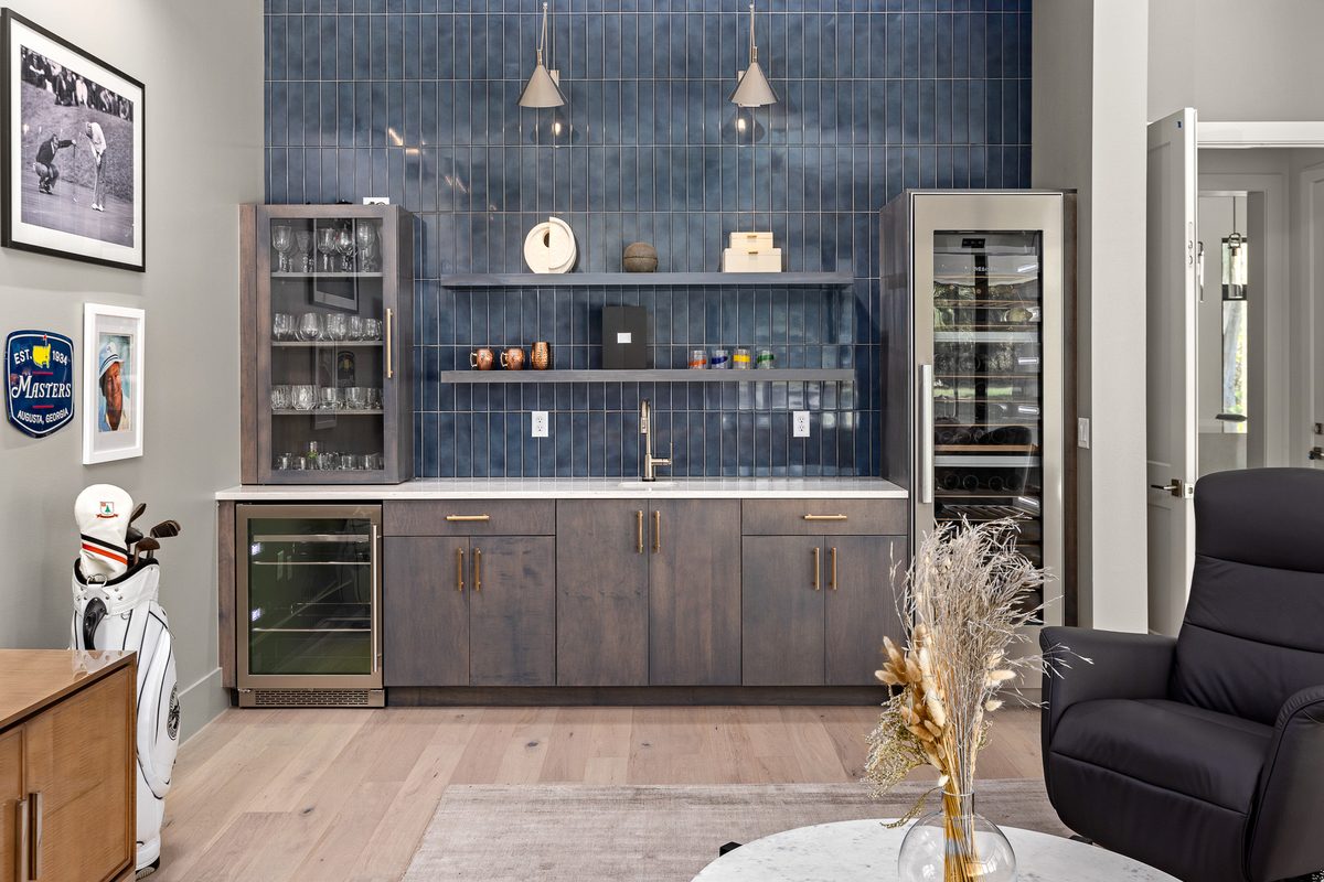Wet bar with deep-blue vertical stacked tile backsplash